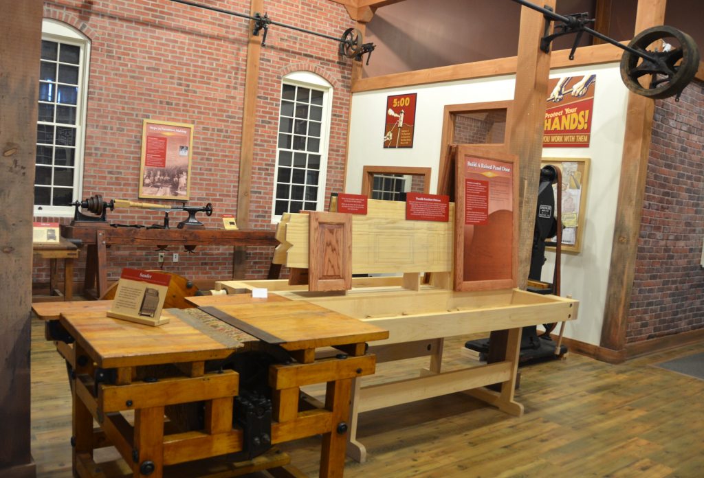 In a factory environment, visitors can use hands-on interactives to assemble doors and learn about the history of furniture making in Rockford.