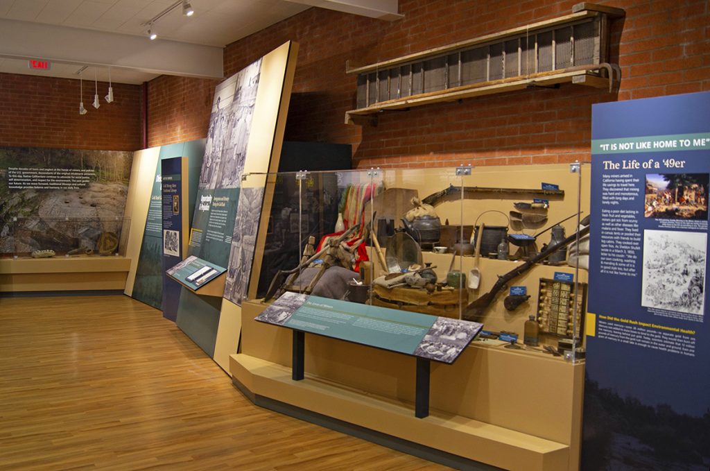 An artifact case displays a range of objects from gold seekers.